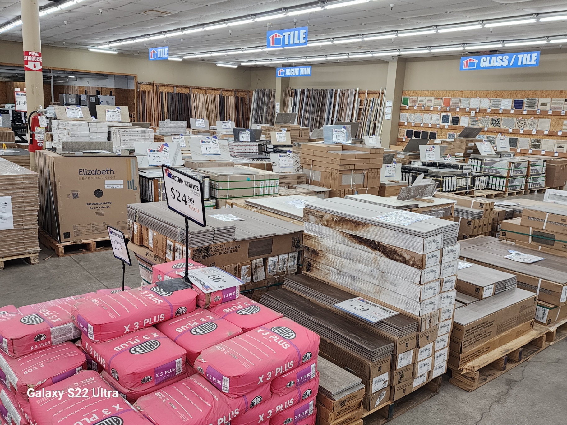 Porcelain and ceramic tile inventory stacked on warehouse pallets